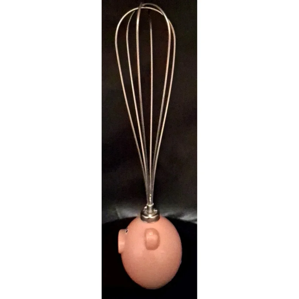 Novelty pig-themed whisk with a pink resin handle. By Jo!e